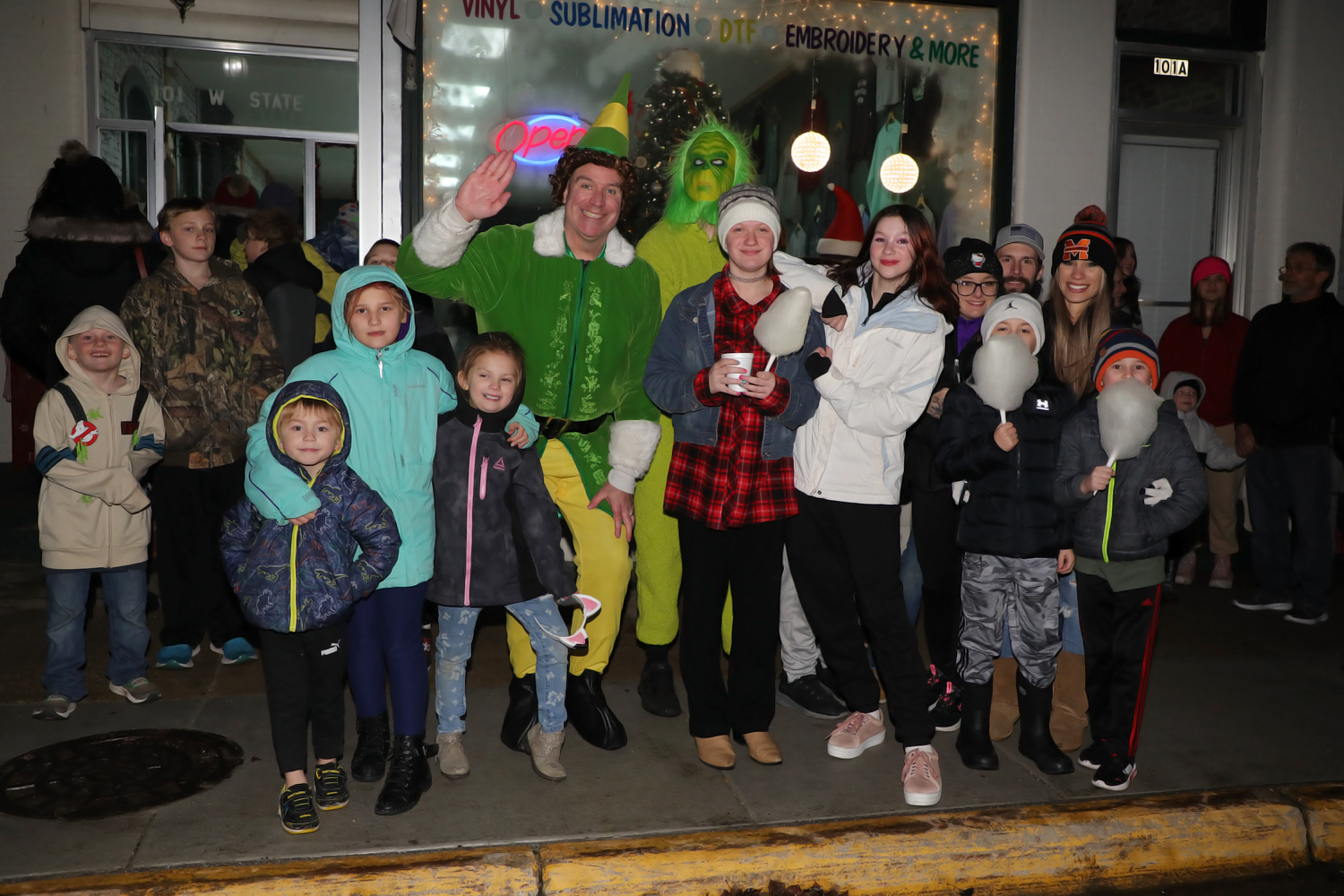 2023 12 09 AR Buddy the Elf Grinch and kids wait outside Days Designs to see Santa IMG 3807